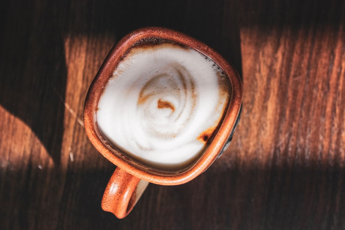 Overhead view of a cappuccino on a wooden table