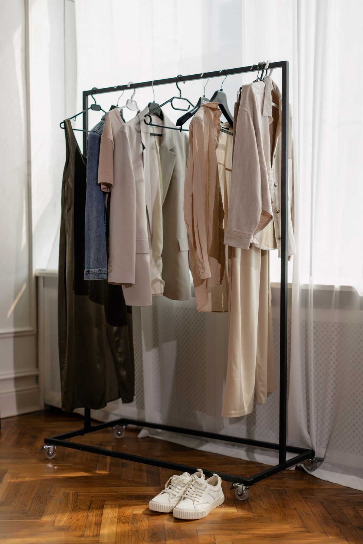 Minimalist clothing rack with neutral-toned garments